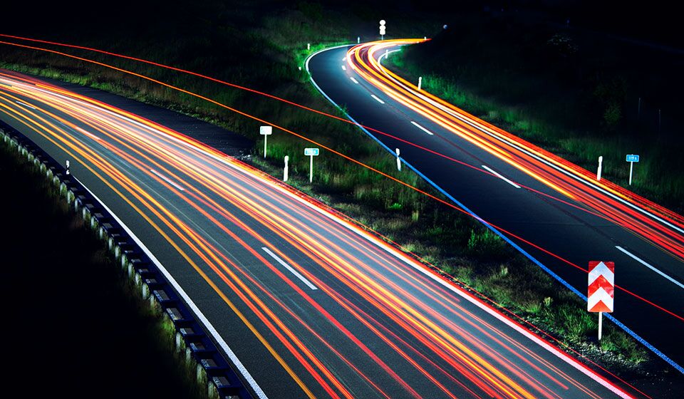 Traffic light trails on road