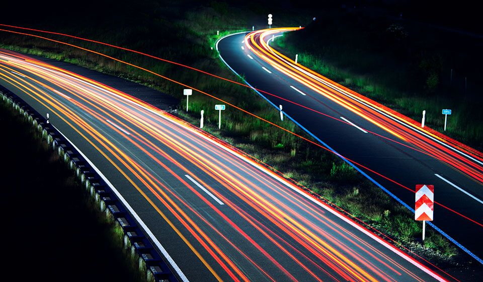 Unified security ecosystem blog hero image-General Purpose Traffic light trails on road