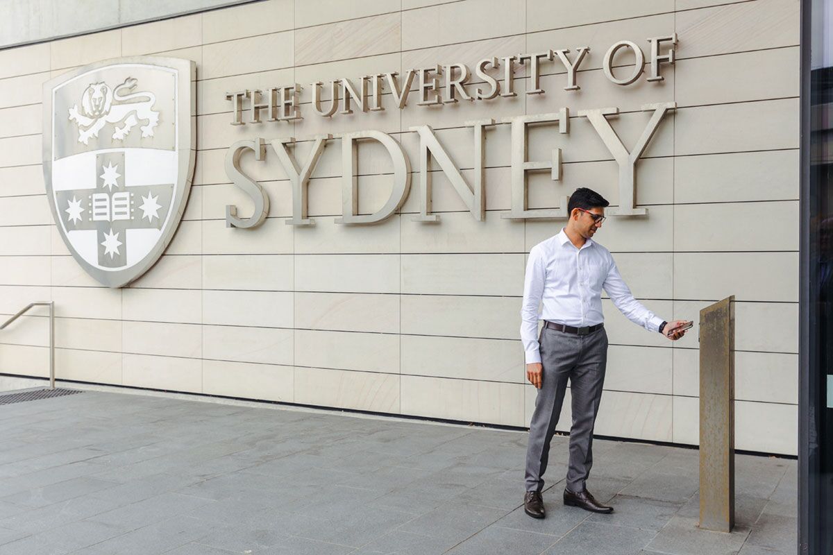 Student badging their mobile credential at a Gallagher Reader at the University of Sydney