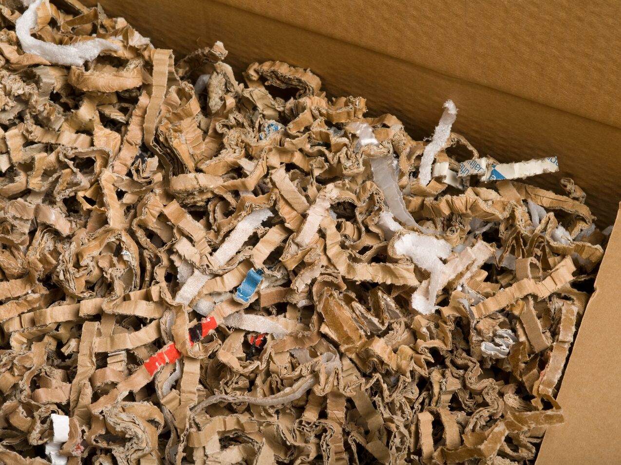 A box filled with shredded cardboard ready to be recycled.