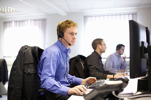 People working in a third-party monitoring call centre