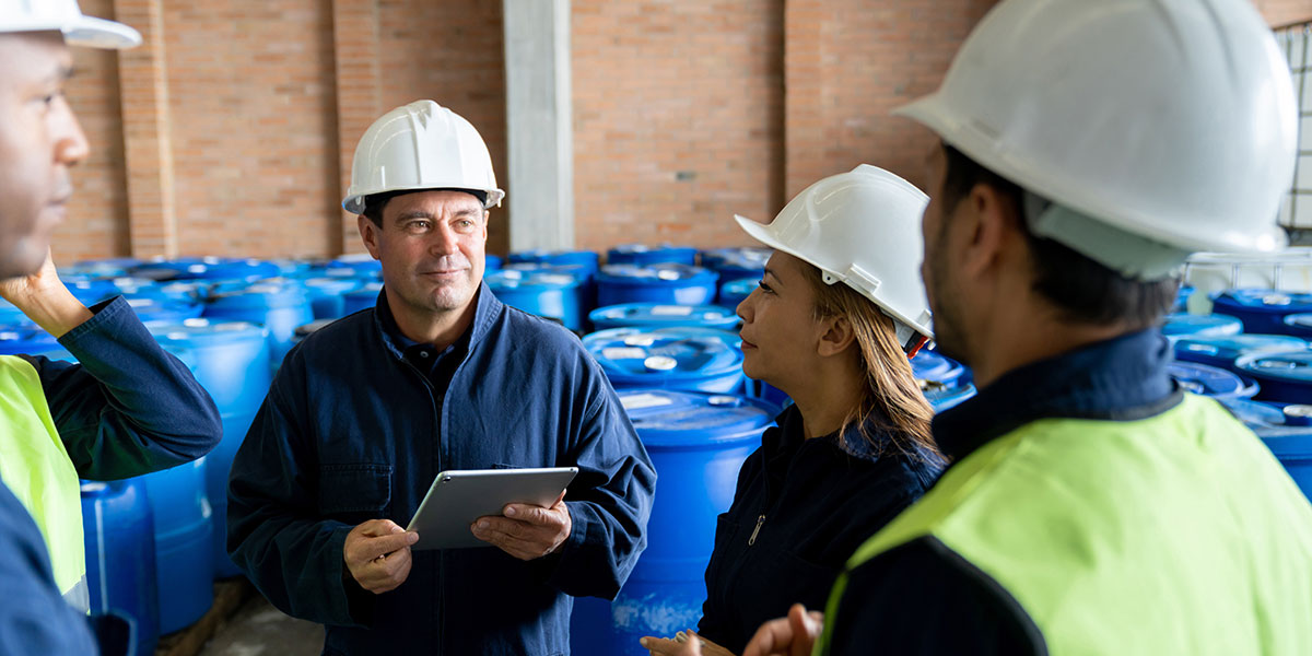 Foreman talking to a group of workers about hazardous materials