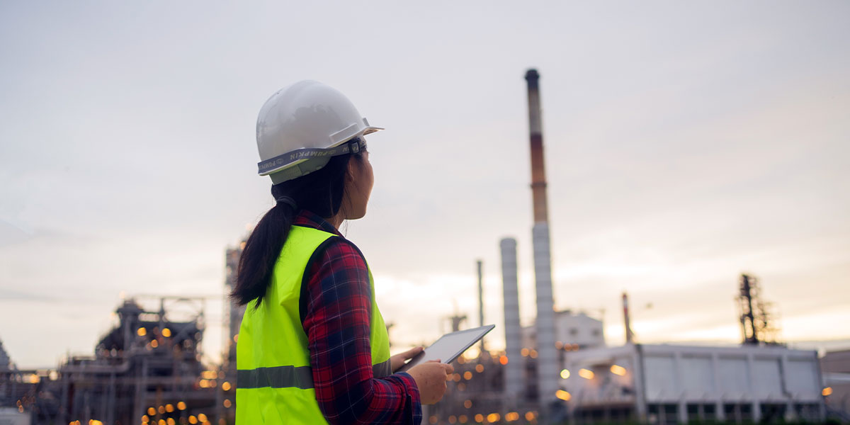 Security engineer in PPE inspecting critical infrastructure site