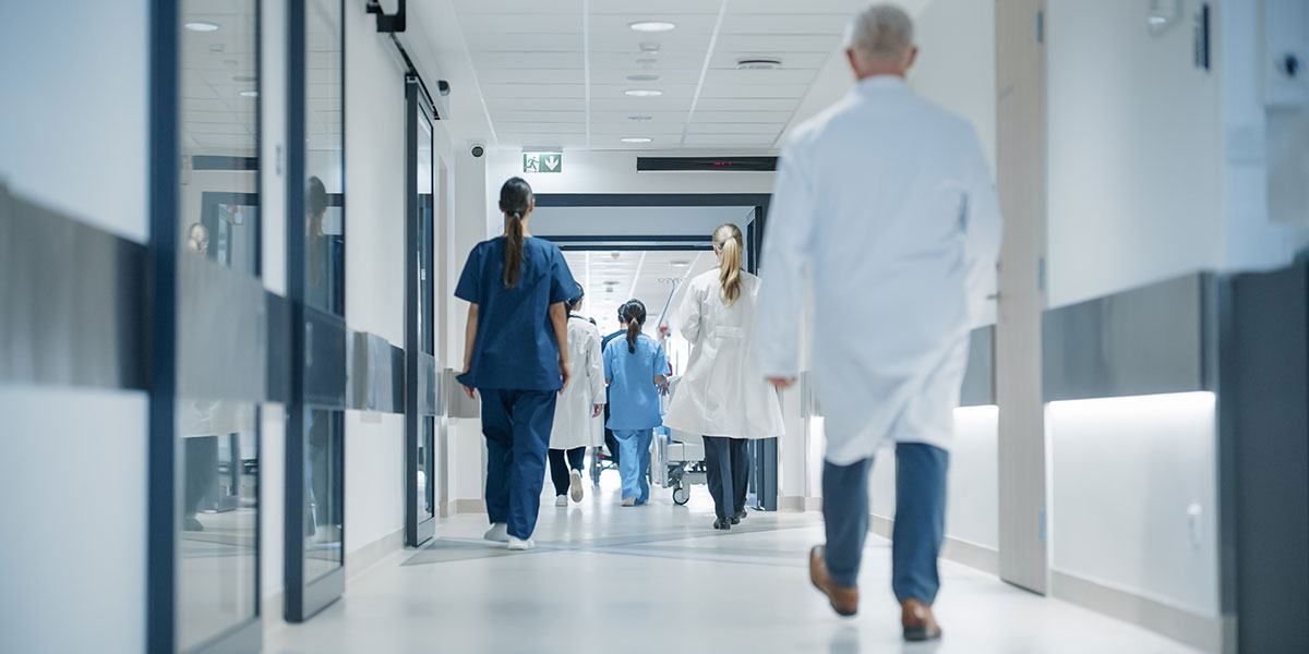 Medical staff walking down hospital corridor