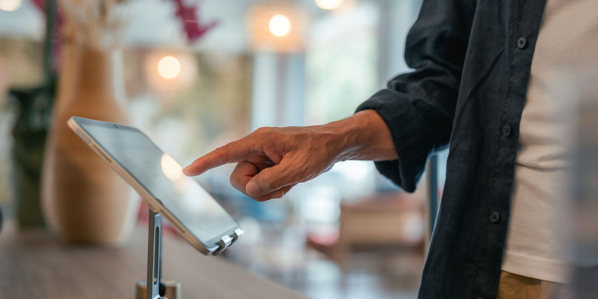 Visitor registering at visitor management kiosk