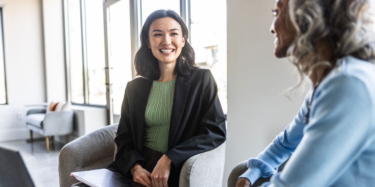 Business person welcoming visitor in lobby