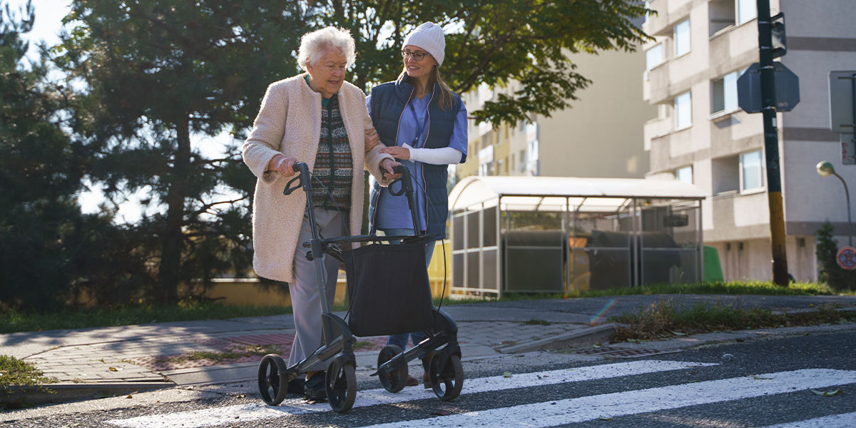 Senior woman and caregiver outdoors