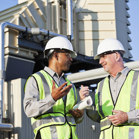 Contact Energy men wearing high vis talking 