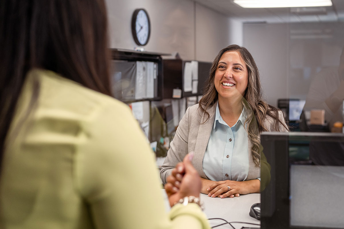 Bank teller smiling at customer