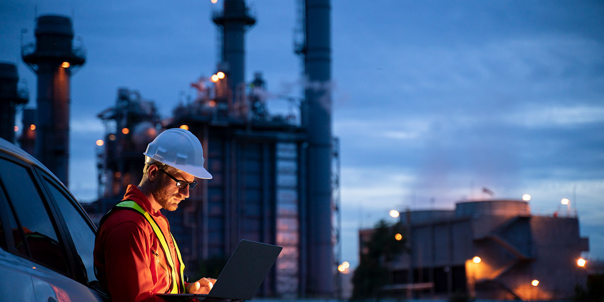 Engineer working at gas facility at night