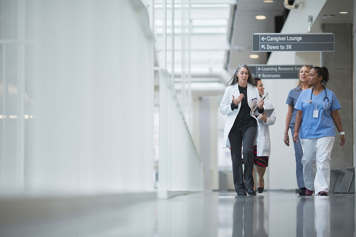 Doctors walk through hospital corridor