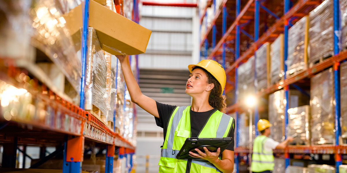 Employee packing order at fulfillment center