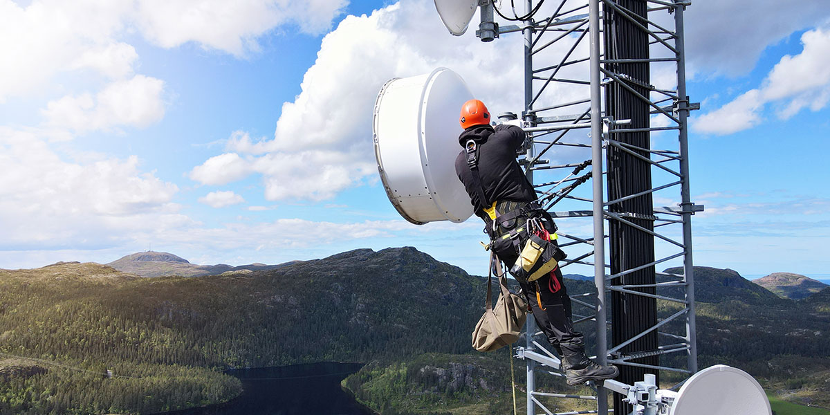 Technician working on telecommunications tower