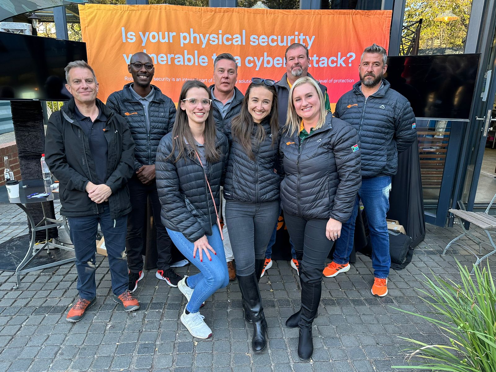 Gallagher Security South Africa team in front of Gallagher banner at Johannesburg Roadshow