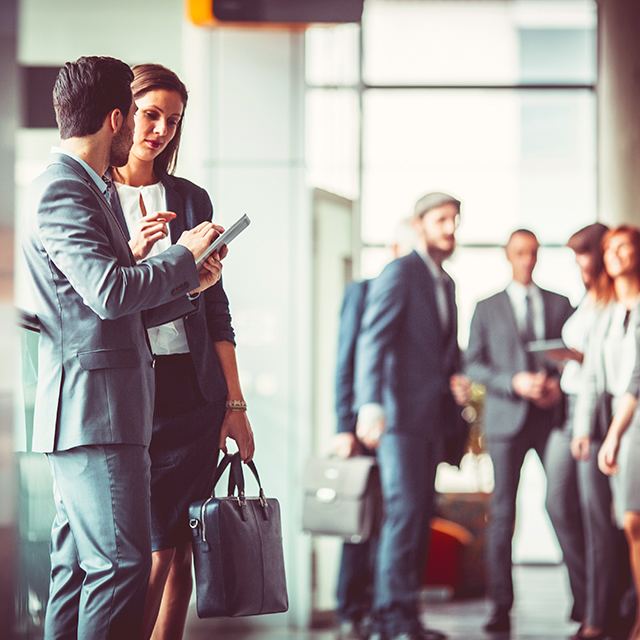 Group of business people in the office building lobby.